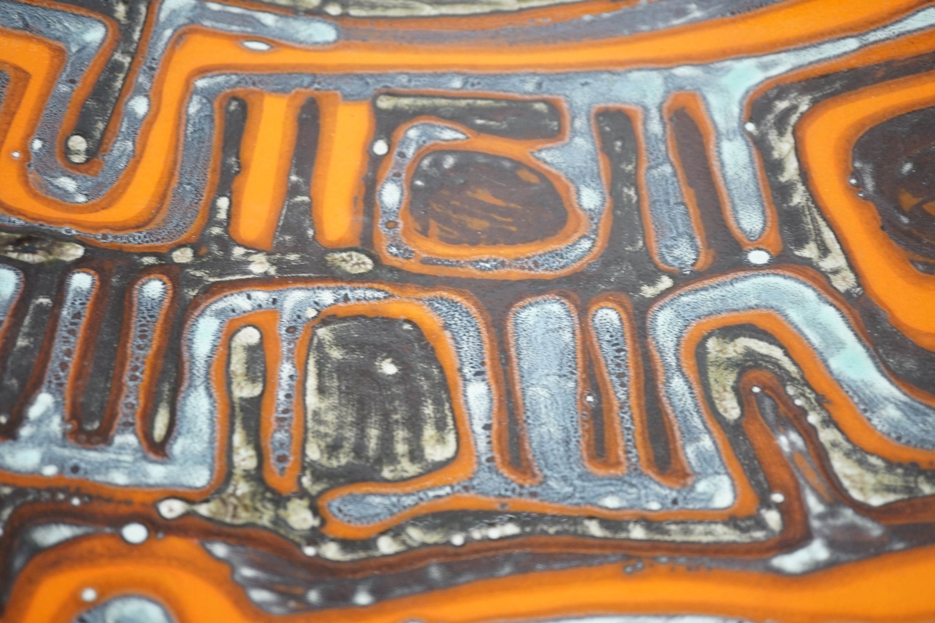 A Poole pottery orange Delphis designed charger-36 cms diameter.
